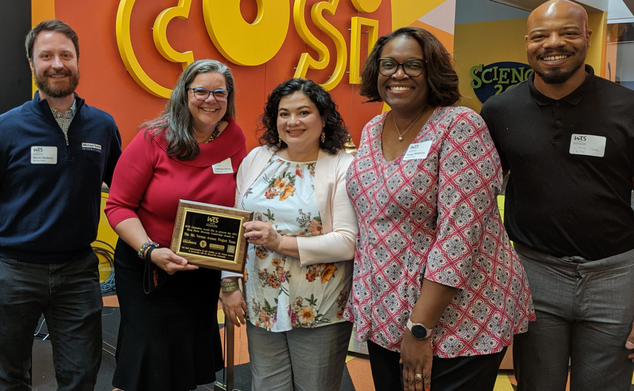 Catherine Girves with award surrounded by people at a WTS conference